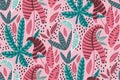 Seamless tropical pattern with tropical plants and leaves on a bright pastel pink background. Fashion Botanical print.